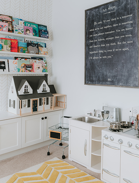 Toys and a play kitchen organized with a California Closets custom playroom storage cabinet