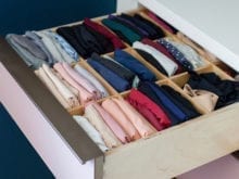Pink dresser drawer with neatly organized clothing