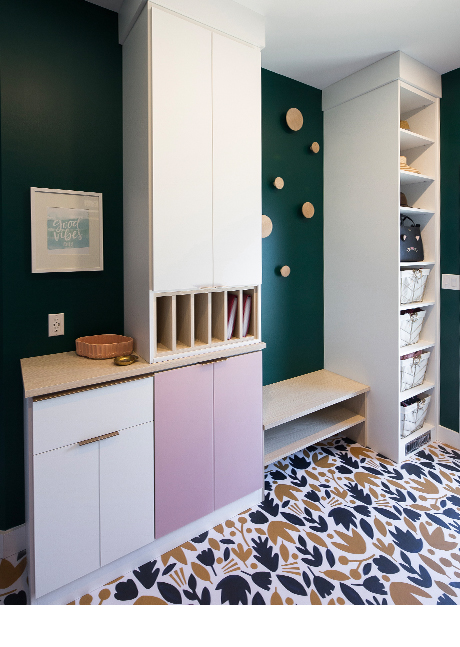 Tall white shelving flanking wooden bench in green room