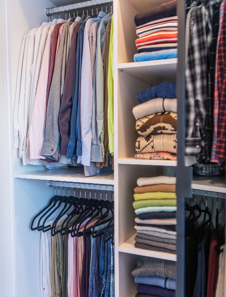 Organized clothes in the custom master closet for Adam Glassman