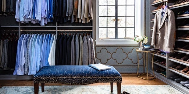 Walk-in closet with blue shirts and shoe shelving designed by Amber Colo and Sarah Smith