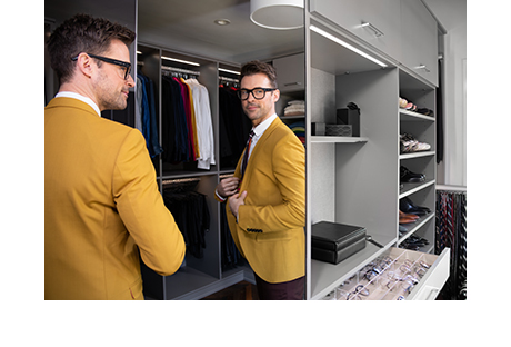 Fashion stylist Brad Goreski admiring his custom master closet by California Closets