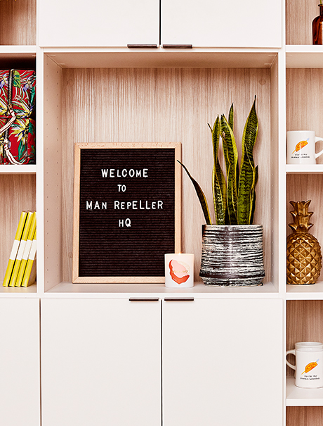 Custom cabinets and shelving in a light wood grain finish created by California Closets