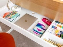 White pullout drawer in wood cabinet | California Closets