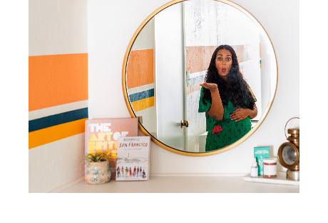 Mirror with gold frame with reflection of Anjelika Temple | California Closets