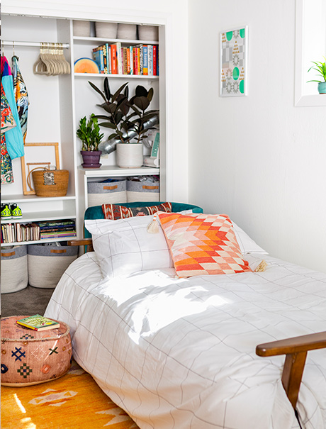 White bed next to custom closet | California Closets