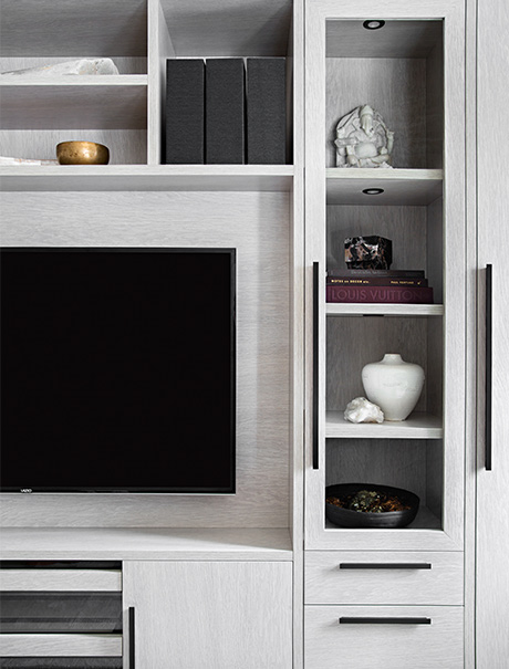 Custom shelving detail and entertainment center in Jeremiah Brent's updated studio by California Closets