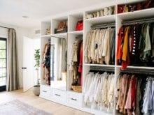 Custom storage for hanging clothes and accessories for Emily Current's newly designed walk in closet by California Closets