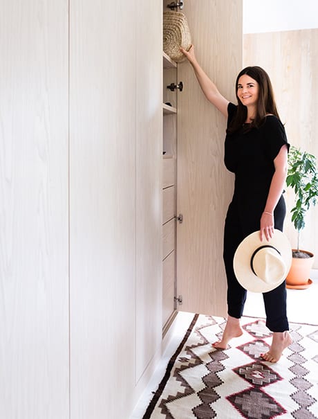 Designer Michelle Adams utilizing her new custom closet | California Closets