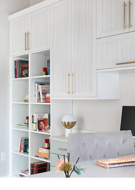 Organized shelves in home office with white and gold accents | California Closets Austin