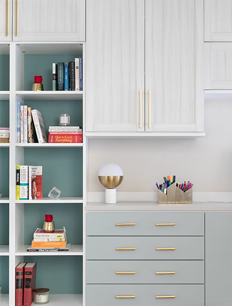 White and gold accented storage in a home office for client Kadija Howes | California Closets Austin