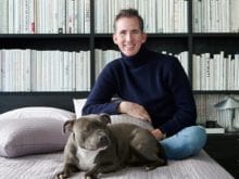 Kevin Sharkey and his dog sitting in his custom library | California Closets
