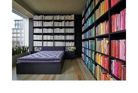 Kevin Shakey's library withrainbow color coordinated books | California Closets