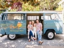 Influencer Kelly Natenshon sits with her husband and children in the Marine Layer van