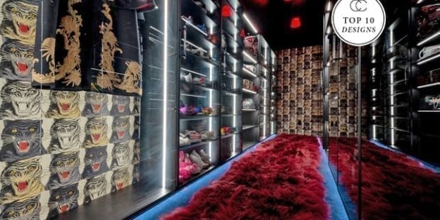 Dark colored walk in closet with burgundy velvet carpet