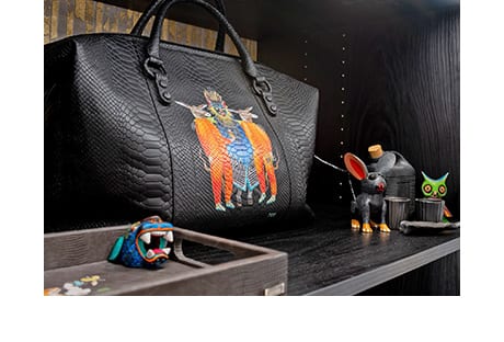Black handbag on display on dark surface