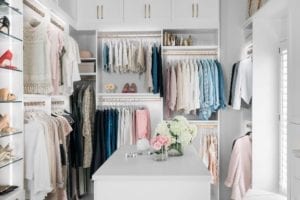 White walk in closet with light clothing for blogger Kelly Page