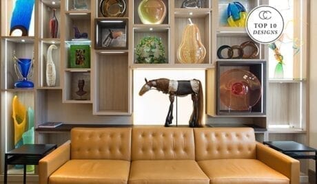 Top 10 Designs tan leather couch with collage shelve wall behind
