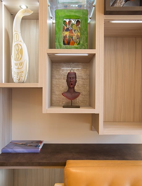 Asymmetrical wooden shelves with various sculptures