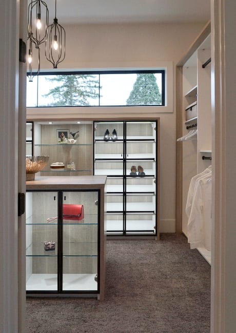 Walk in closet with clear glass display doors