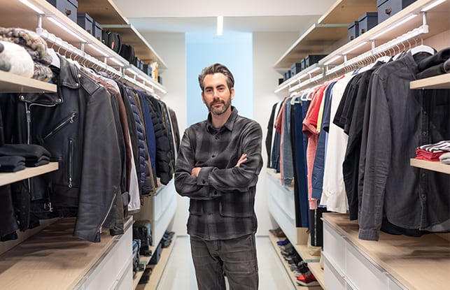 Architect Dan Brun standing in his custom walk in closet