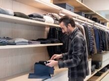 Architect Dan Brunn putting items away in his custom closet by California Closets