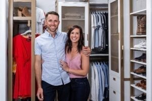 two people posing infront of custom walk-in closet | California Closets 