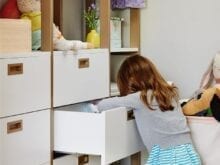 A girl organizing custom drawers | California Closets