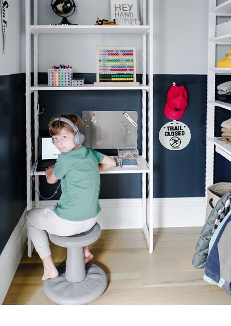 Kid utilizing custom office desk cabinet | California Closets