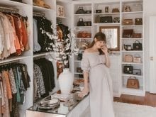 Custom walk-in closet with lady standing in a dress | California Closets 