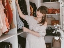 Lady picking clothes from custom closet | California Closets 