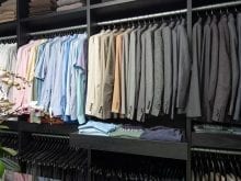 Custom closet with multiple color shirts | California Closets