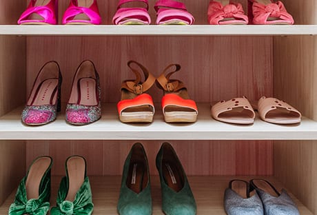 Custom shelves with different type of shoes | California Closets