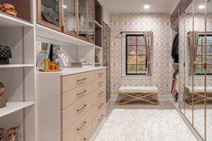 Custom walk-in closet with furry white rug | California Closets