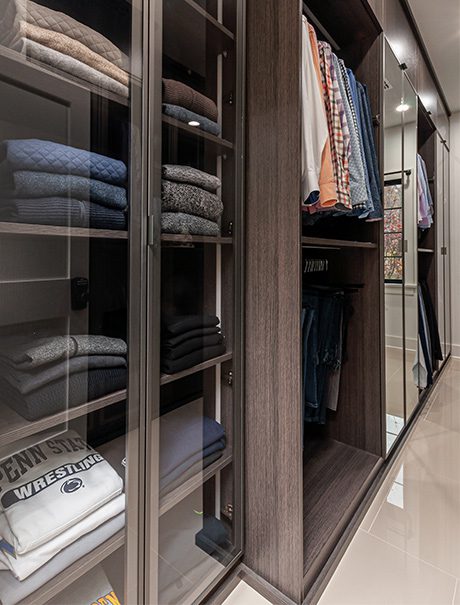 Custom cabinet with folded clothes | California Closets