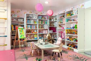 Custom pink playroom with many storage dressers | California Closets