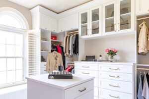 Custom white walk-in closet with center island dresser | California Closet 