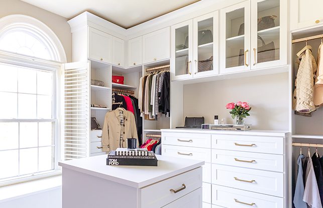 Custom white walk-in closet with center island dresser | California Closets