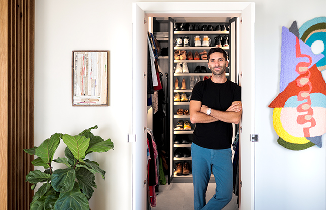 Nev Schulman standing in front of custom closet with a custom shoe rack | California Closets