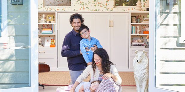 Ariel Gordon with her family of four, custom white closets and floral walls