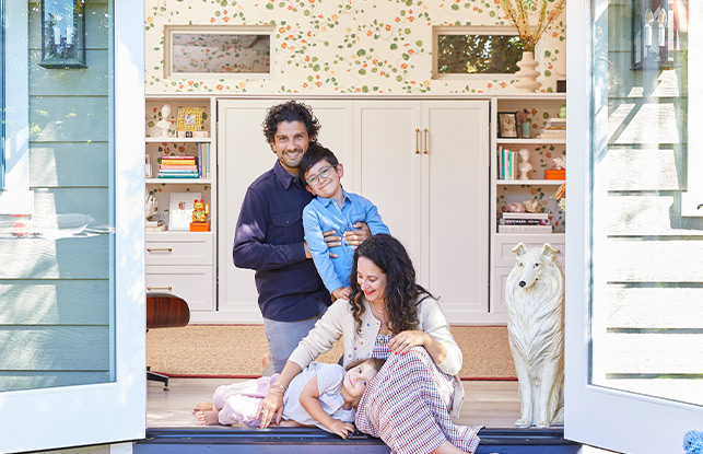 Ariel Gordon with her family of four, custom white closets and floral walls