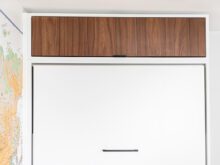 Custom white and wood finish door dresser by California Closets