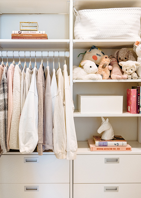 Custom white closet with multiple jackets