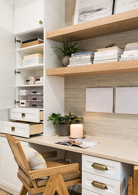 Custom home office desk with custom built in shelves in a light wood grain