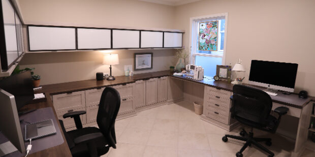 Custom home office with black desk chairs and custom countertop