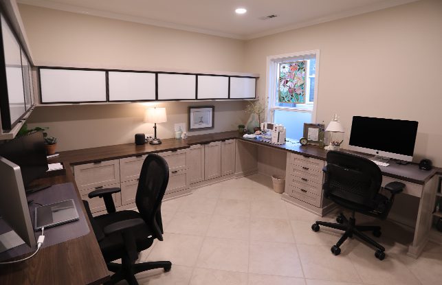 Custom home office with black desk chairs and custom countertop