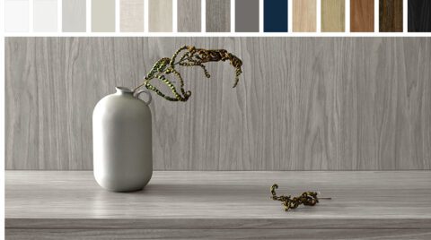 Variety of cabinet finishes from white to black and a light grey cabinet with vase holding a fern