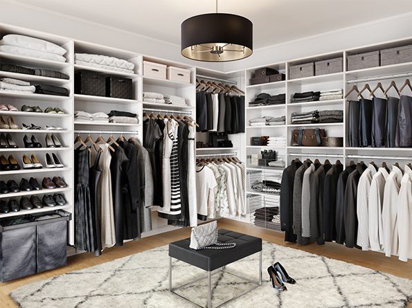 Walk in closet with shelving, shoe storage, hanging racks and cubbies in white wood grain finish designed by California Closets