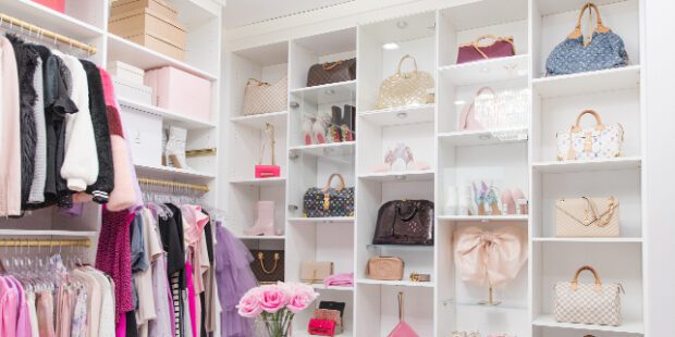 Custom walk in closet solution in a white cabinet finish designed