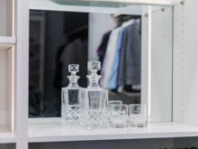 Custom glass set on a custom white shelf with a built in mirror